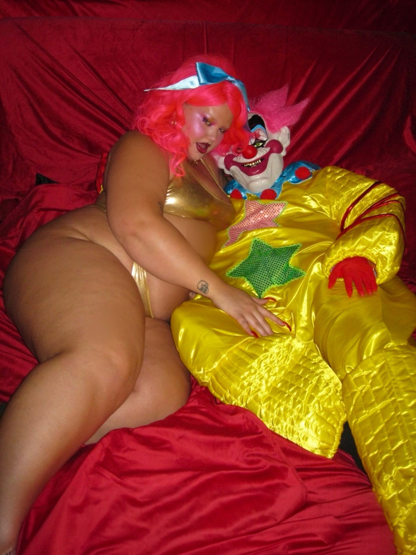 sweet lady k lounging in gold lamé with a killer klown